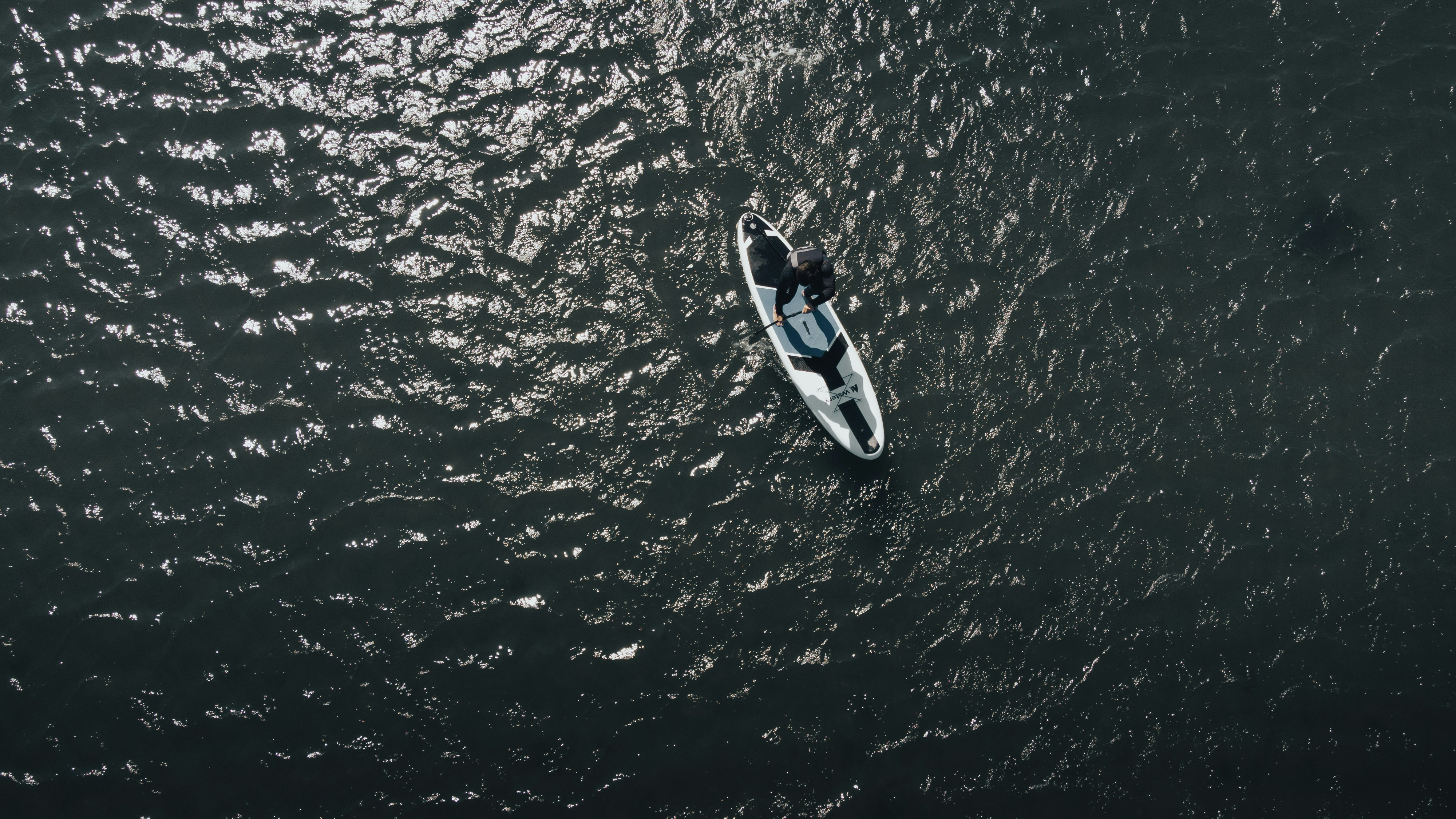 white and blue boat on body of water during daytime